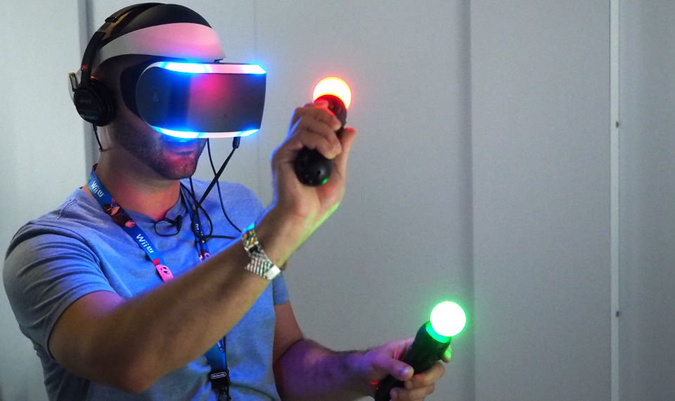 A person wearing a virtual reality headset and holding two glowing motion controllers.